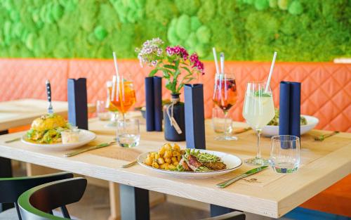 a wooden table with plates of food on it at MARKTWIRTSCHAFT Restaurant & Hotel in Freudenstadt