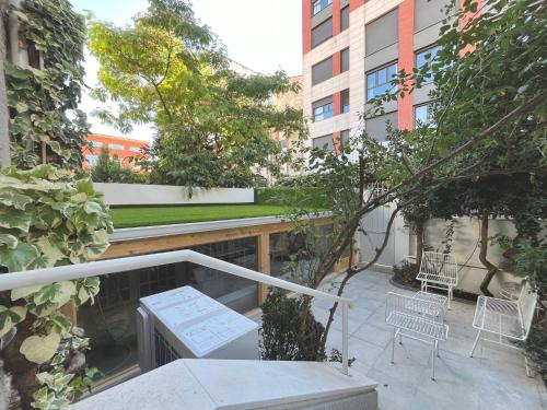 a balcony with a table and chairs in a building at El Jardín de María Luisa Suites in Burgos