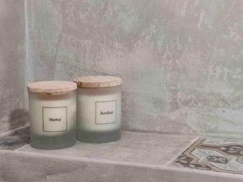two candles are sitting on a shelf in a room at Nazare Townhouse near Lighthouse & Big Waves in Nazaré
