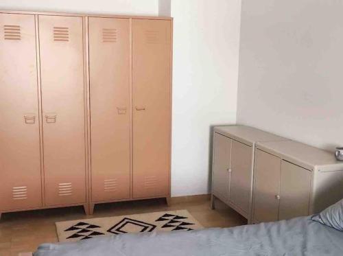 a bedroom with two closets and a bed and a desk at Nazare Townhouse near Lighthouse & Big Waves in Nazaré