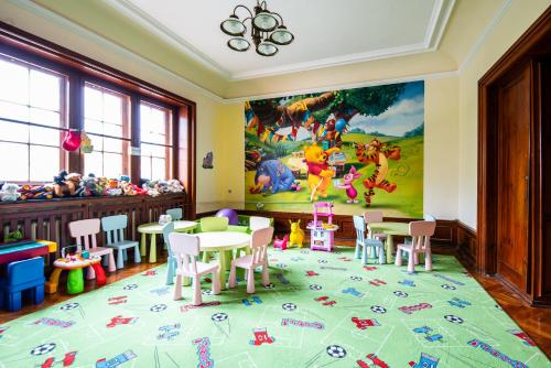 a room with tables and chairs and a mural at Rewita Rogowo k Kołobrzegu in Rogowo