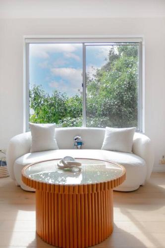 a living room with a coffee table in front of a window at Cozy Studio walk to Park & Water in Sydney