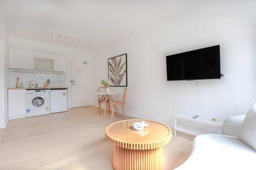 a living room with a couch and a table at Cozy Studio walk to Park & Water in Sydney