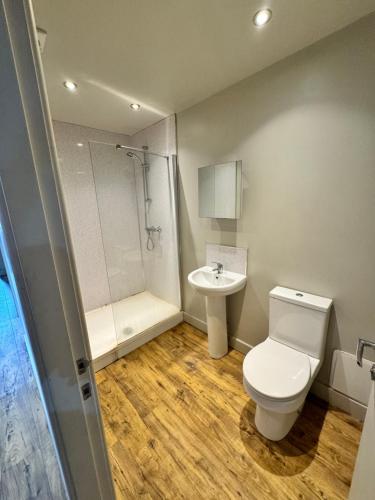 a bathroom with a toilet and a sink and a shower at Private room - Shared Bathroom, Wakefield in Wakefield