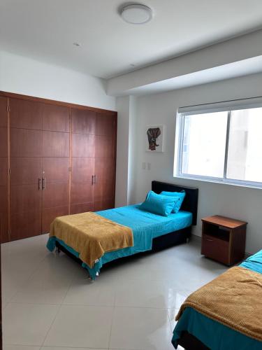 a bedroom with two beds and a large window at Cartagena De Indias in Cartagena de Indias
