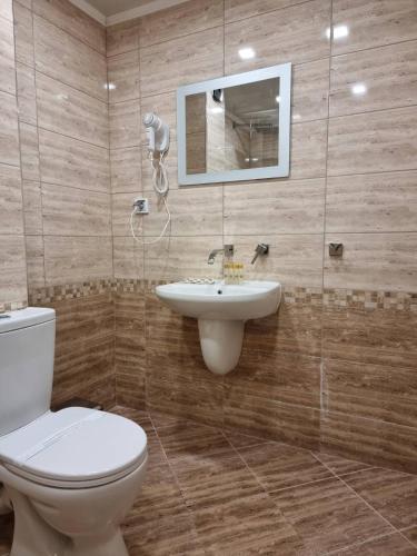 a bathroom with a toilet and a sink at Family Hotel Alfa Vita in Sozopol
