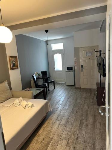 a bedroom with a bed and a living room at Ave Hotel Victoriei in Bucharest
