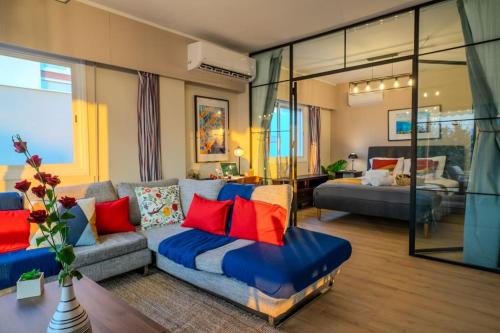 a living room with a couch with red and blue pillows at Two Bedroom Apartment, Spacious & Newly Renovated, Three Minutes from the Beach in Limassol