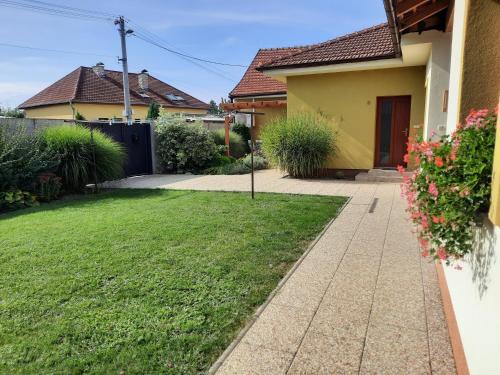 a yard with a house and a driveway at Penzion Kateřina in Mikulčice