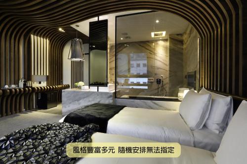 a hotel room with a bed and a mirror at Boda Hotel in Taichung