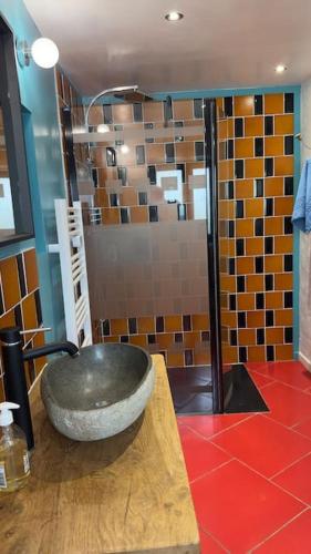 - une salle de bains avec un grand bol en pierre sur un comptoir dans l'établissement gîte Walden 4-6 personnes, à La Chabanne