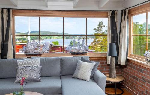 a living room with a couch and a large window at Beautiful Home In Skjeberg With Kitchen in Skjeberg