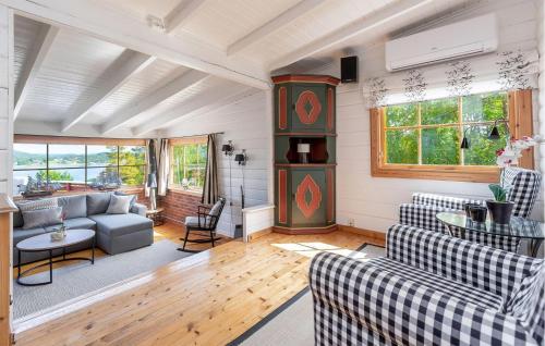 a living room with two couches and a grandfather clock at Beautiful Home In Skjeberg With Kitchen in Skjeberg