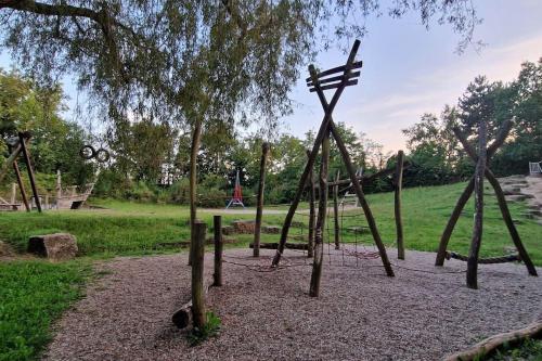 a park with a playground with a swing set at Wohnen am See in Ingelheim am Rhein