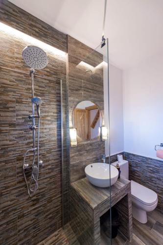 a bathroom with a shower with a sink and a toilet at The View - Lake Resort & Spa in Rugineşti