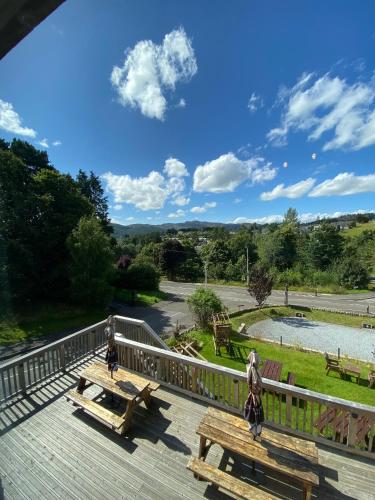 two people riding horses on a wooden deck at Craigvrack Hotel & Restaurant in Pitlochry