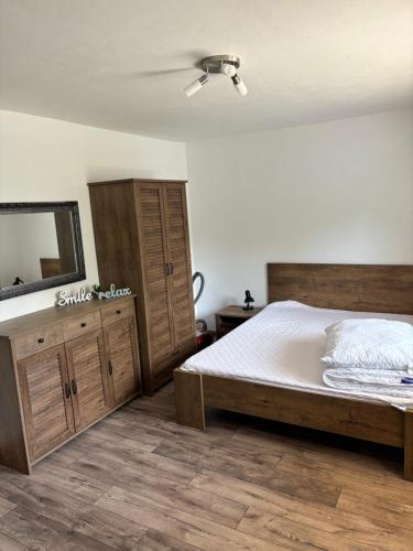 a bedroom with a bed and a dresser and a mirror at Domček u strýka 1 in Lazisko