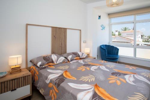 a bedroom with a large bed and a window at La Palapa Beach in Benalmadena Costa