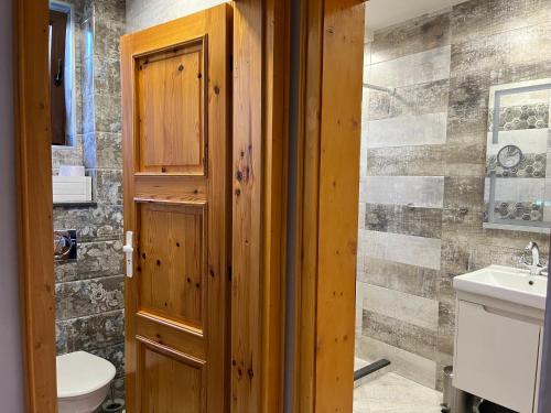 a bathroom with a toilet and a sink at Одеса 37 in Sozopol