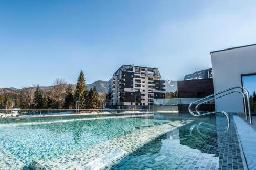 a swimming pool on the side of a building at Apartament Silver Mountain Resort & Spa Poiana Brasov in Poiana Brasov