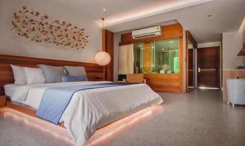 a bedroom with a large bed and a dining room at Sichon Cabana Beach Resort in Sichon