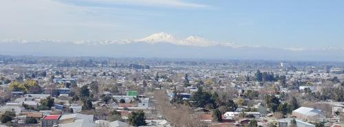 an aerial view of a city with mountains in the background at Depto Cómodo y Equipado en el Centro de Chillan con Estacionamiento in Chillán