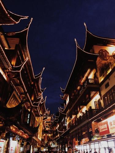 a city street with tall buildings at night at Nostalgia S Hotel Shanghai Railway Station & Suzhou Creek 时光漫步S酒店上海火车站苏州河店 Free fresh ground coffee,Free laundry service in Shanghai