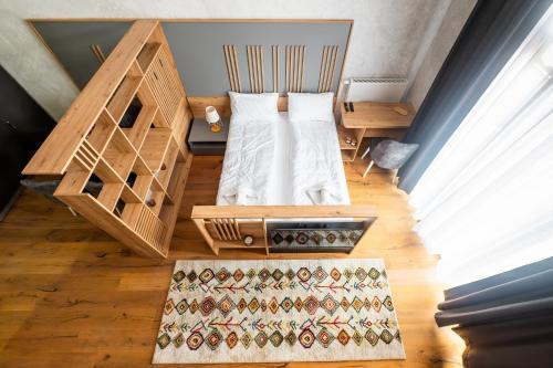 a small bedroom with a bed and a desk at Mountain Magic Bjelašnica in Bjelašnica