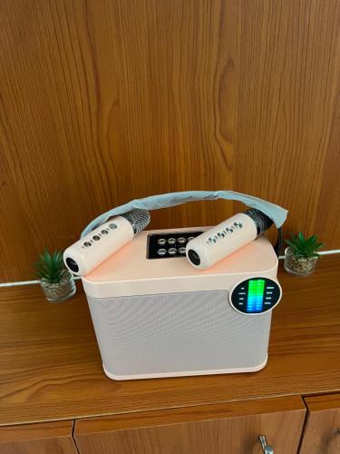 two remote controls sitting on top of a box on a cabinet at SMDC Wind Residences Tower 4 Taal view in Tagaytay