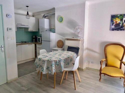une cuisine avec une table et des chaises dans une pièce dans l'établissement Studio lumineux avec balcon, Wi-Fi, proche des thermes d'Amélie-les-Bains - FR-1-703-52, à Amélie-les-Bains-Palalda