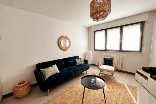 un salon avec un canapé noir et une table dans l'établissement Nancy Centre Superbe F2 avec Garage, à Nancy