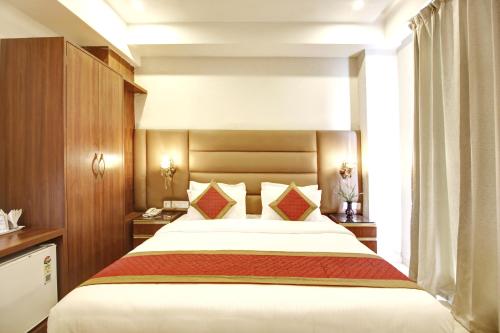 a bedroom with a large bed in a room at Marks Hotel & Banquet in Noida