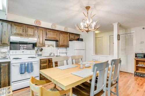 a kitchen with a wooden table and a dining room at Renovated Ski-InandSki-Out Peru Condo at Bromley Mtn in Peru