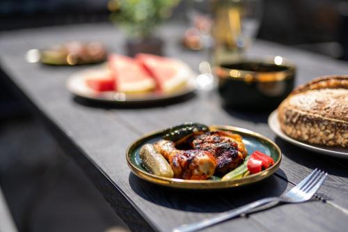 a table with plates of food on a table at Resort Červený dvůr in Rapotín