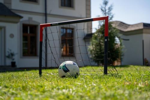 a soccer ball sitting in front of a goal at Resort Červený dvůr in Rapotín