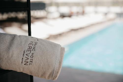 a towel with the words harrods on a window at Grand Hotel Yerevan - Small Luxury Hotels of the World in Yerevan