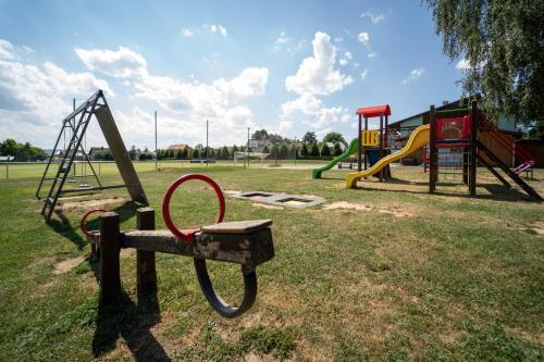 a park with a playground with a swing at Resort Červený dvůr in Rapotín