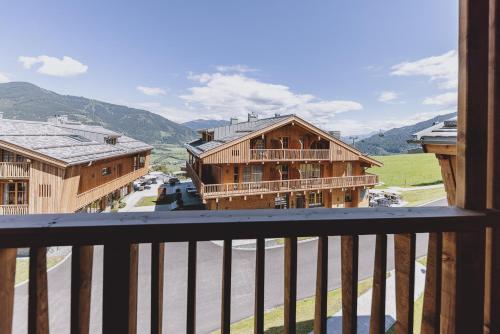 a balcony with a view of a street and buildings at CHALET VILLAGE ZAGLGUT Wellness & Views with Summer Card Included in Kaprun