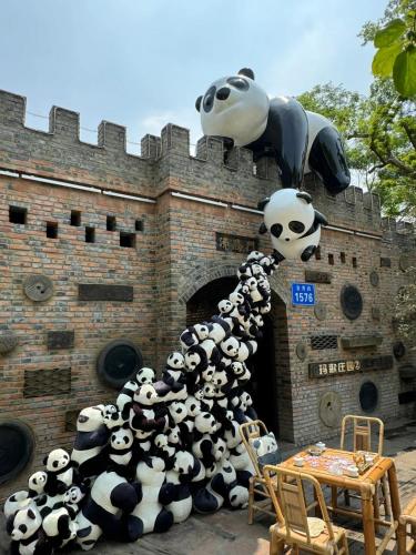 a group of giant pandas in front of a building at Nost algia S Hotel Chengdu KuanZhai Alley & Renmin Park 时光漫步S酒店 成都宽窄巷子人民公园地铁站店 Free fresh ground coffee,Free laundry service in Chengdu