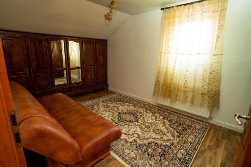 a living room with a couch and a window at Vila Zona Centrală in Zalău