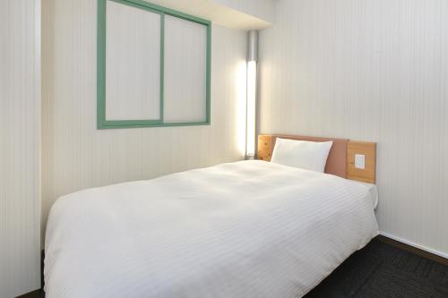 Postel nebo postele na pokoji v ubytování Washington R&B Hotel Kumagaya Ekimae