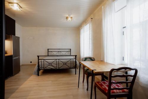 a dining room with a table and a bed at Von Aghte Small Studio in Kuressaare