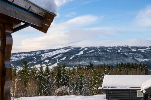 a view of a snowy mountain from a house at ReveEnka - cabin in Trysil with Jacuzzi for rent in Trysil