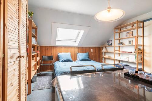 a bedroom with a bed and bookshelves at Cozy room in residential Alkmaar - Free parking in Alkmaar
