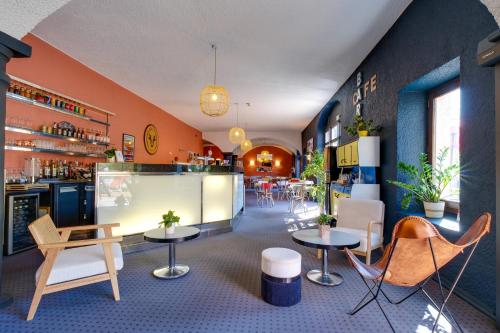 a restaurant with tables and chairs and a bar at Sure Hotel by Best Western Annecy in Annecy