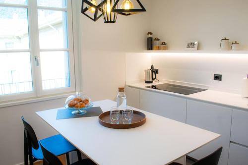 a kitchen with a table with a bottle and glasses on it at Eleganza nel Cuore di Como in Como