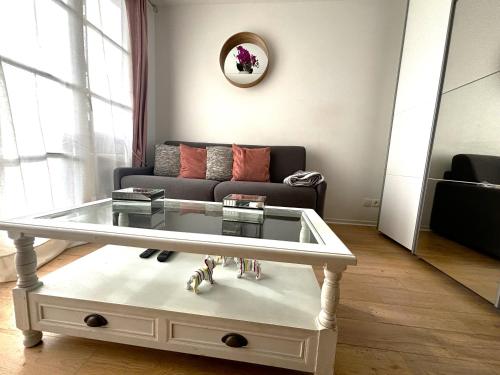 a living room with a couch and a coffee table at Cosy Disney Studio - Disneyland Paris in Chanteloup-en-Brie
