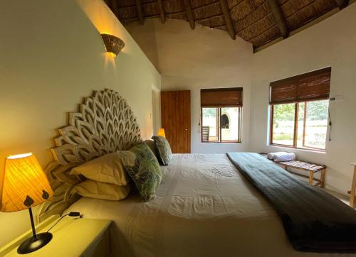 a bedroom with a large bed in a room at Frog Mountain Getaway in Swellendam