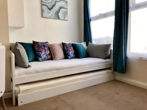 a couch sitting in a room with a window at Eastbourne Pier Apartments in Eastbourne