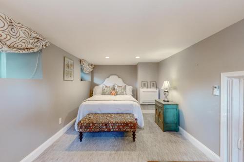 a bedroom with a bed and a bench in it at Historic White Manor in Timonium